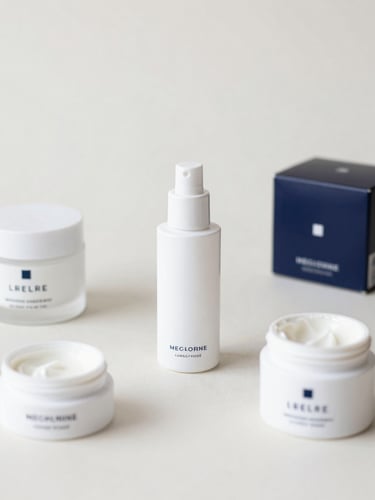 An organized flat lay of premium consumer goods on a clean neutral background, soft professional studio lighting.