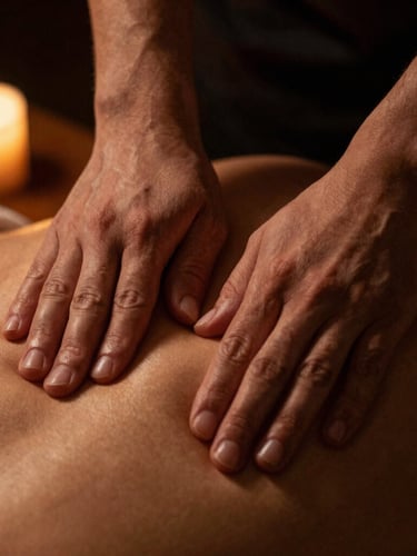 Macro close-up of hands applying precise pressure to a client's upper back, warm candlelit glow, deep shadows, rich gold and black tones, shallow depth of field, focus on the hands and muscle texture.