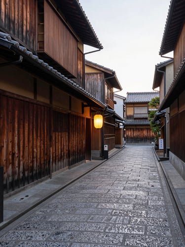 Wide environmental shot looking down a narrow Kyoto alley at dawn, wooden machiya facades receding to the left, pale morning light raking across the stone pavement, a single paper lantern glowing softly at mid-frame, no people, no filters