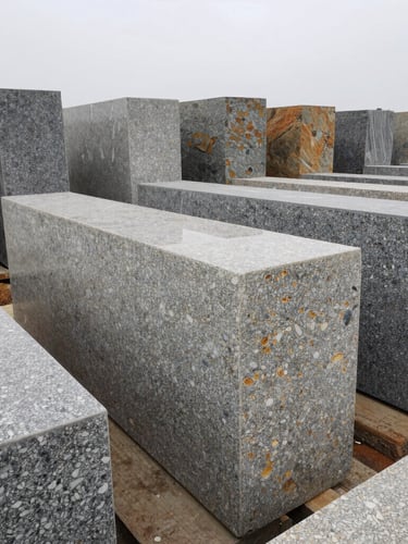 A monumental wide-angle shot of standing exotic granite slabs arranged in rows inside the Chinhat stone yard, soft diffused overcast daylight reflecting off the polished travertine and quartz surfaces, sharp texture detail.