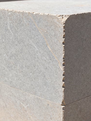 Extreme close-up of premium raw limestone block, sharp structural lines, crisp Mediterranean daylight, architectural photography