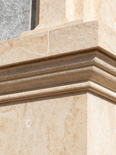 Extreme macro detail of architectural limestone texture, warm cream tones, sharp structural lines, high-performance insulation material visible behind, crisp Mediterranean daylight, 35mm