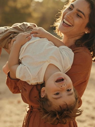Close-up of a mother laughing as she holds her child upside down, warm golden sunlight streaming through trees, authentic emotions, 35mm film aesthetic