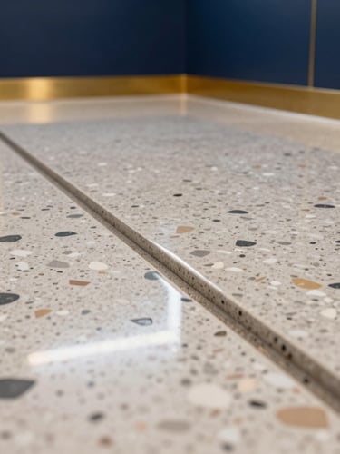 Extreme close-up macro architectural photography of a commercial terrazzo floor being polished, showing the sharp boundary between a dull worn surface and a flawless glossy finish reflecting overhead lights, crisp clean highlights, 35mm