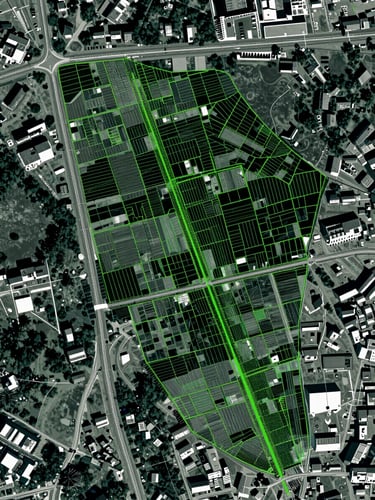 Top-down satellite GIS overlay of land parcels with sharp green vector boundary lines, cool-toned technical photography, high-contrast, 35mm