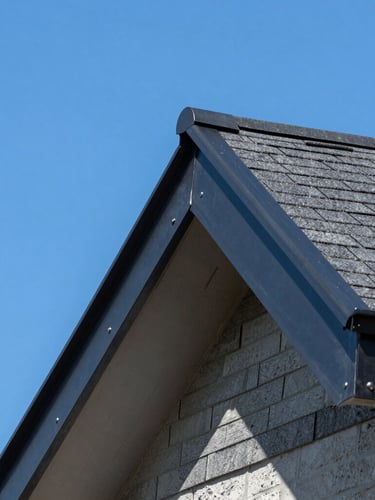 Close-up architectural shot of high-quality charcoal metal flashing and architectural shingles on a clean roof edge, bright clear daylight, vivid blue sky