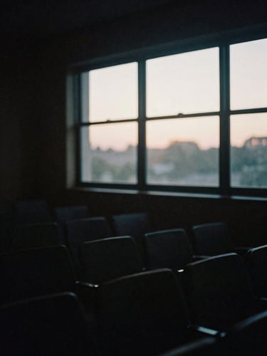 Moody film photography of empty recording space at twilight, soft window light filtering through dust motes, 35mm.