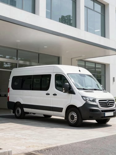 Branded AJCPHOTOGRAPHY LLC mobile studio van parked at a modern office building entrance, professional photographer setting up gear, crisp natural daylight, high-contrast tones