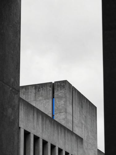 Architectural geometry of Crystal Palace South London, sharp concrete lines against a high-contrast overcast sky, minimalist urban framing with deep shadows.