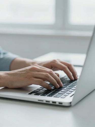 Close-up of hands typing on a laptop in a bright, minimalist workspace, neutral daylight, soft corporate blue tones, sharp focus, 35mm
