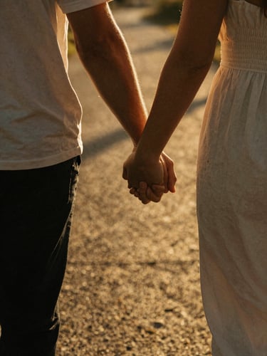 Intimate close-up detail of a couple holding hands while walking through golden-hour shadows, warm backlighting, deep natural shadows, cinematic 35mm film aesthetic