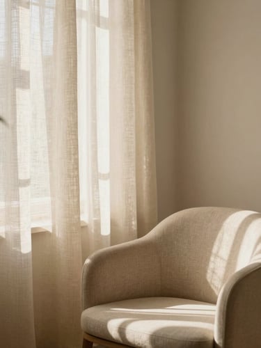 Serene interior of a minimalist private beauty studio, soft beige linen curtains, a single comfortable chair, warm natural sunlight filtering through a window, plant leaf shadow