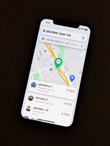 Overhead flat-lay of a phone displaying a Google Maps local pack search result for 'plumber near me', three business pins visible on the map with review counts annotated, one pin highlighted in a muted green, screenshot-native lighting, no hands or physical props