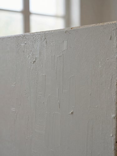Extreme close-up of a textured oil painting canvas with heavy palette knife marks, soft side daylight from a gallery window, neutral grey undertones