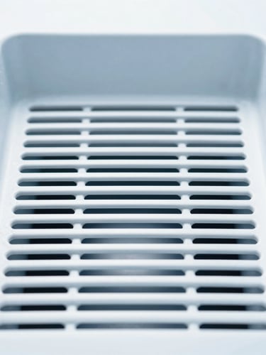 Straight-on clean ventilation grate interior, clinical white and cool blue tones, bright daylight, 35mm lens