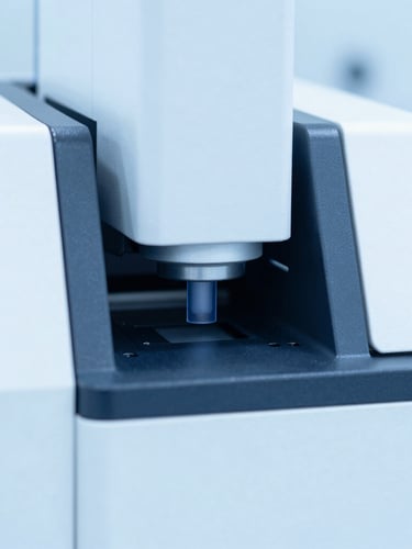 macro shot of a high-performance liquid chromatography machine in a sterile laboratory, bright clinical high-key lighting, sterile blue and white tones, sharp focus, 35mm