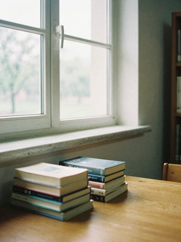 Quiet corner of the campus library with soft natural window light, books stacked on a wooden table, 35mm film aesthetic.