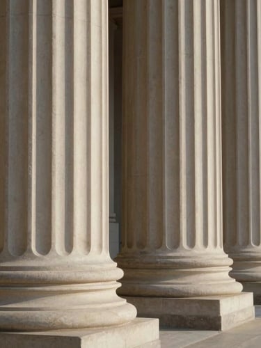 Architectural close-up of classical stone columns, soft natural side light, deep shadows, elegant sovereign legal aesthetic.