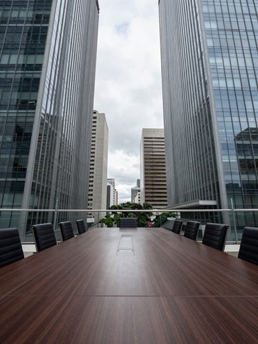 Symmetrical wide shot of an empty high-rise boardroom in São Paulo, cool overcast daylight, architectural glass and steel lines, minimalist design.