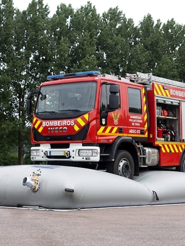 a red fire engine parked on water bags