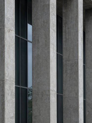 Abstract architectural crop of concrete columns and glass, cool diffused daylight, sharp geometric shadows, wide angle