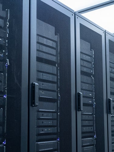 Crisp architectural photography of a secure modern server facility, cool daylight filtering through glass, deep blue and metallic gray tones, sharp focus, 35mm