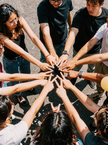A vibrant group photo of creative professionals in a huddle, high-contrast natural daylight, energetic saturated colors, 35mm film feel