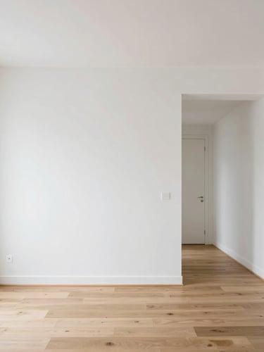 Bright architectural photography of a modern renovated Parisian living room, natural daylight, clean white plaster walls, minimalist oak floor, 35mm lens