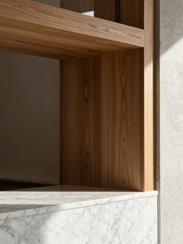 Architectural detail of custom walnut carpentry meeting a white marble counter, warm natural lighting, close-up geometric composition, editorial photography