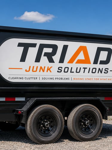 A black Triad Junk Solutions trailer for professional junk removal and hauling services.