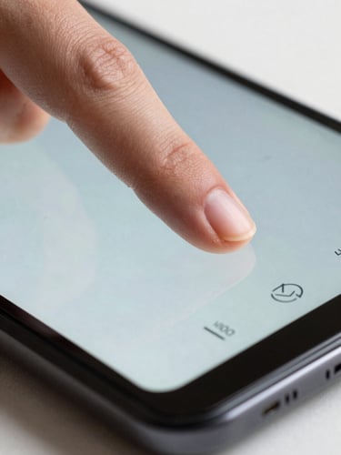 Extreme close-up, overhead studio lighting, a single index finger resting on an Android device screen mid-swipe, the interface visible beneath the fingertip showing a task completion state — bright even lighting, sharp focus on finger and glass, no background visible