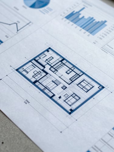 Close-up of technical architectural drawings on a desk, overlaid with structured financial charts and spreadsheets, cool corporate lighting, 35mm