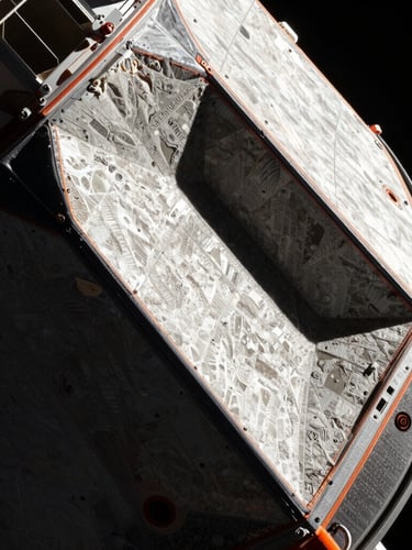 Extreme close-up of the Orion spacecraft heat shield, highlighting textured silica tiles under harsh direct sunlight of vacuum space, deep shadows, 70mm cinematic aerospace photography.