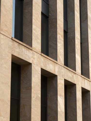 Architectural close-up of a modern corporate limestone facade, sharp geometric shadows, warm morning sunlight, 35mm.