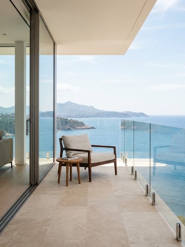Crisp architectural photography of a minimalist luxury balcony with structural glass railing, bright natural daylight, clean glass reflections, 35mm