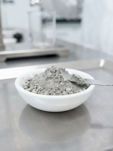 Macro photograph of clean dry cement powder being tested in a clinical laboratory under sharp white lighting, high contrast, minimalist composition.