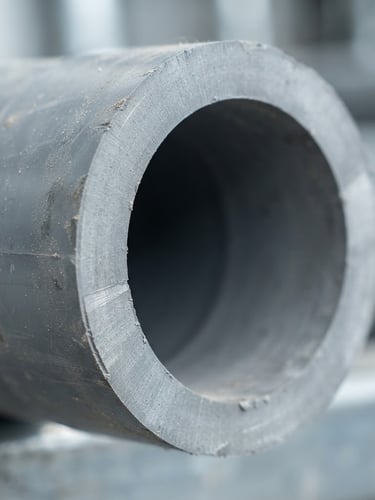 Macro close-up of heavy-duty schedule 80 PVC pipe wall thickness, clean industrial daylight, sharp focus, 35mm
