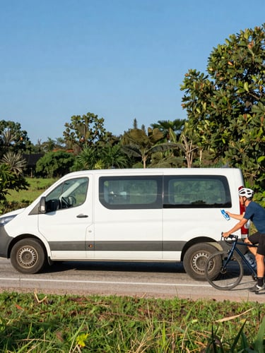 A support van parked on the shoulder of a quiet country road, driver handing a fresh water bottle to a cyclist, warm afternoon light.