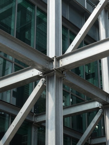 Tight macro architectural detail of interlocking steel beams and glass joints, sharp daylight, high contrast, 35mm lens