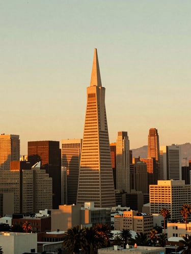 Saturated warm retro film photo of San Francisco skyline at golden hour, Transamerica tower prominent, warm orange glow, 35mm style.
