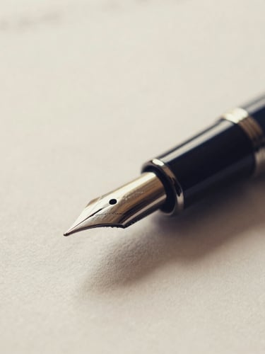 Macro close-up of a fountain pen resting on a crisp legal document, warm paper background, soft directional window light, shallow depth of field