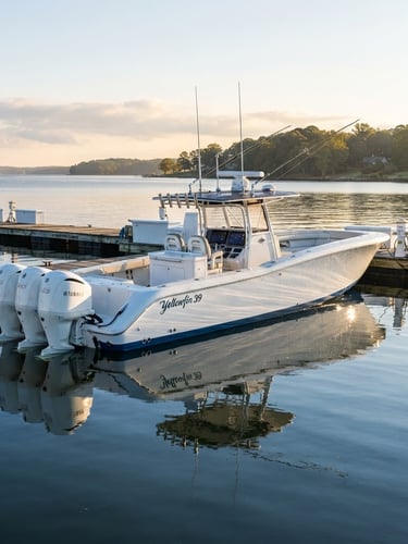 Wide shot of a pristine high-end center console boat at a private dock in Virginia, reflecting the morning sun like a mirror, water beading on the hull, low horizon, crisp editorial marine photography