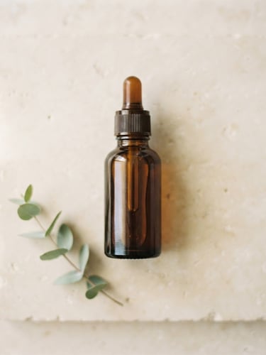 Minimalist flat-lay of amber glass Ozem27 bottle on a clean cream stone surface, soft natural morning light, muted sage tones, shallow depth of field