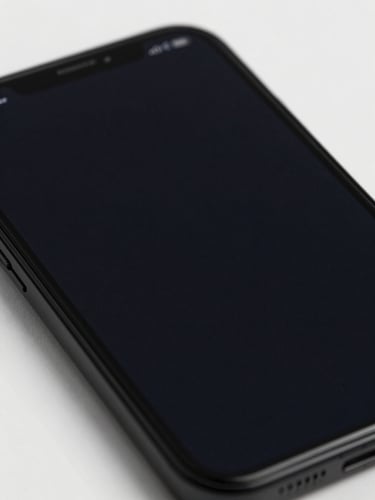 Extreme close-up of an Android phone screen displaying a minimal dark UI, cool studio light eliminating all glare, sharp edges of the glass visible at the frame, matte black device body filling the lower portion, flat overhead angle showing proportion and restraint