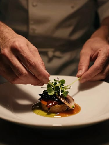 Moody cinematic food photography, close-up of a chef finishing a plated dish with microgreens, dramatic low-key lighting, deep shadows, rich warm amber tones, 35mm shallow depth of field