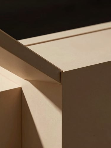 Close-up of an architectural joint on a high-end exhibition stand structure, showcasing premium materials and sharp, clean lines under dramatic lighting, high-contrast, warm sand tones.