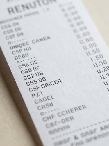 Macro close-up of an itemized retail receipt with printed customs classification codes, bright neutral daylight, clean workspace background, sharp focus on structured data.
