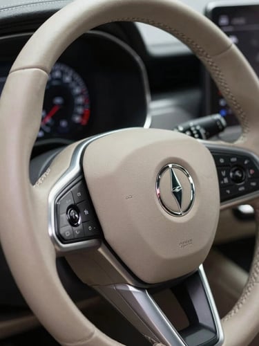 Tight macro shot of a clean leather steering wheel and digital dashboard of a premium car, soft studio lighting