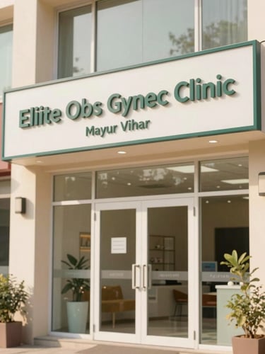 Exterior shot of Eliite Obs Gynec Clinic entrance in Mayur Vihar, Delhi, showing clear signage, bright and welcoming, soft natural light.