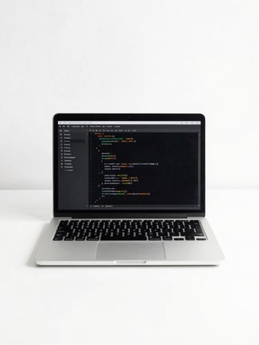 Minimalist clean workspace with a laptop open showing code, bright natural daylight, sharp focus, high-contrast monochrome tones